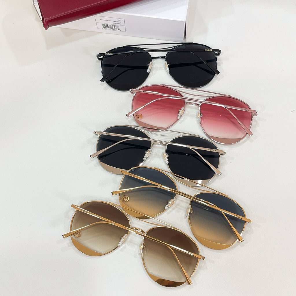 Set of five Gucci sunglasses with red, pink, black, and gold frames