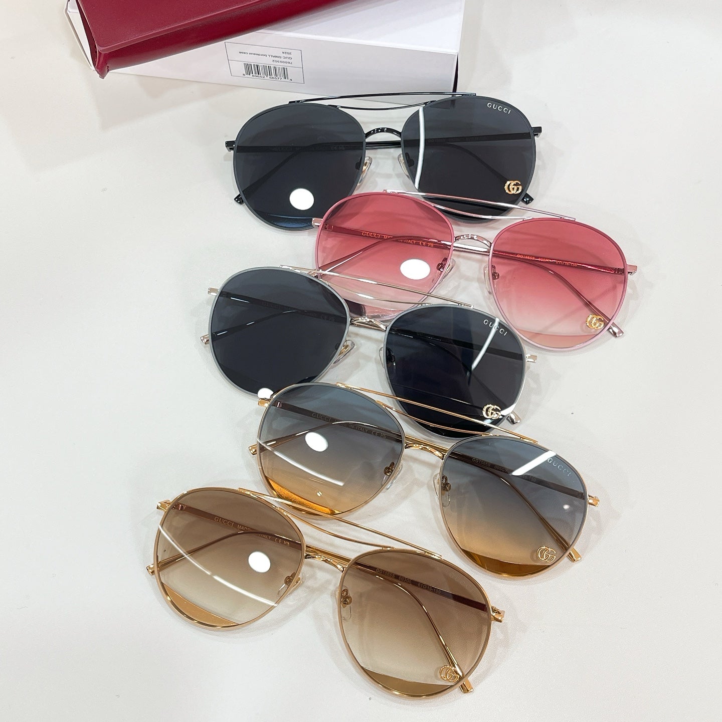 Set of six Gucci sunglasses with black, red, brown, and gold frames
