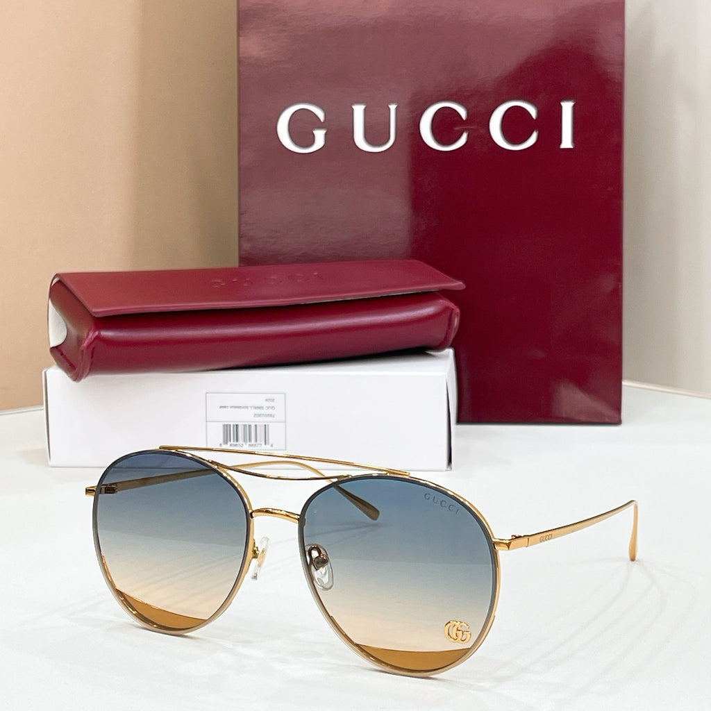 Round Gucci sunglasses, gold metal frame with light blue tinted lenses