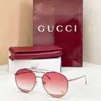 Round Gucci sunglasses, pink tinted lenses, silver metal frame