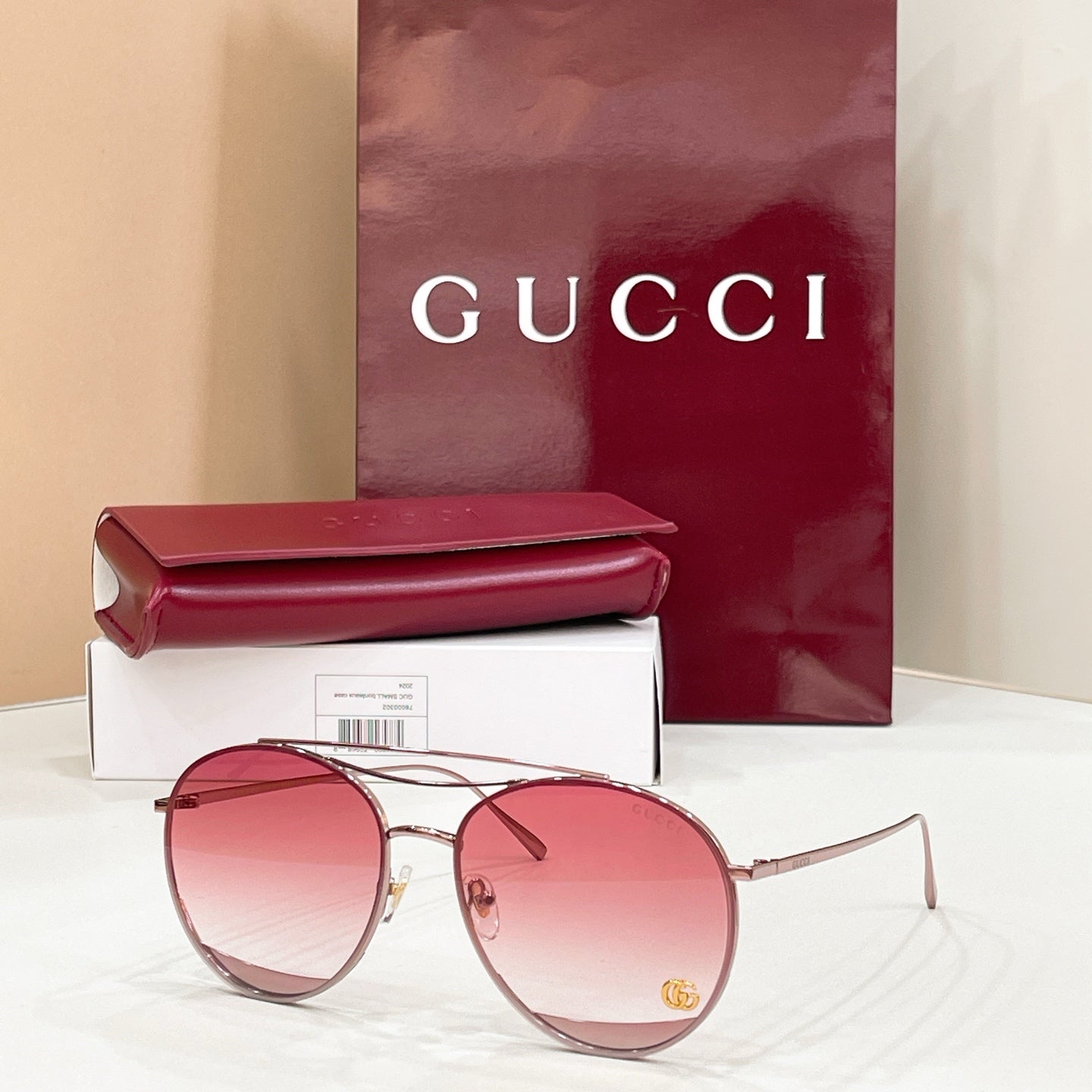 Round Gucci sunglasses, pink tinted lenses, silver metal frame