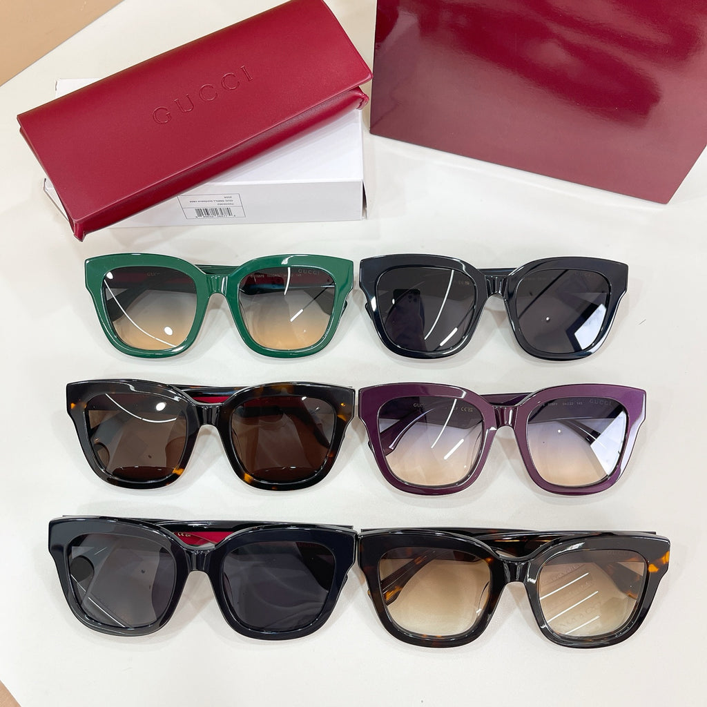 Set of Gucci eyeglasses with green, black, purple, and tortoiseshell frames.