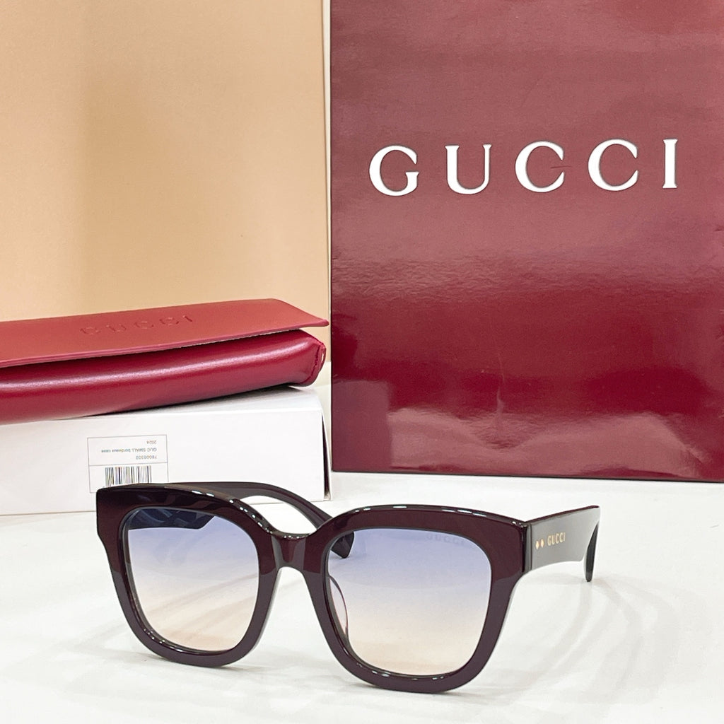 Dark maroon square eyeglass frames with clear lenses and Gucci logo temples.
