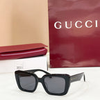 Square black sunglasses with dark lenses and glossy thick frames