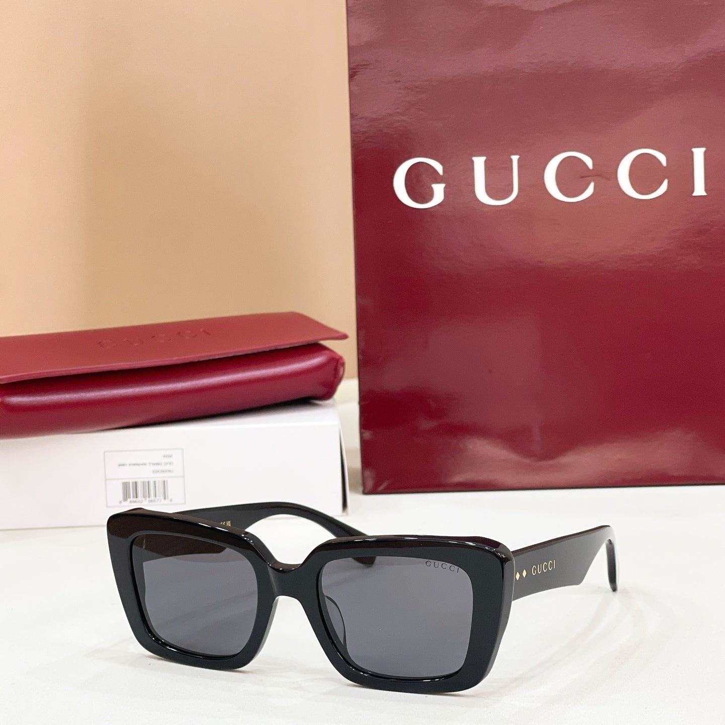 Square black sunglasses with dark lenses and glossy thick frames