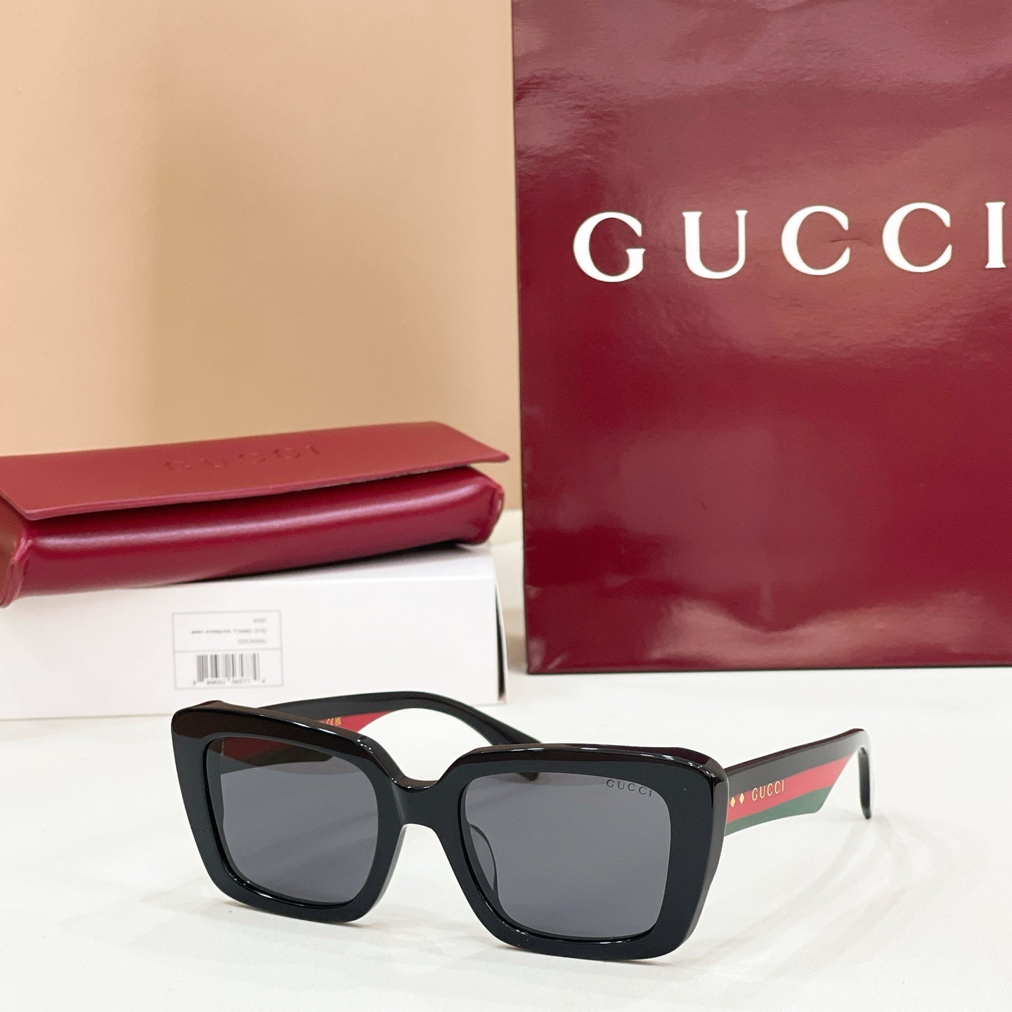 Square black sunglasses with dark lenses and thick frames