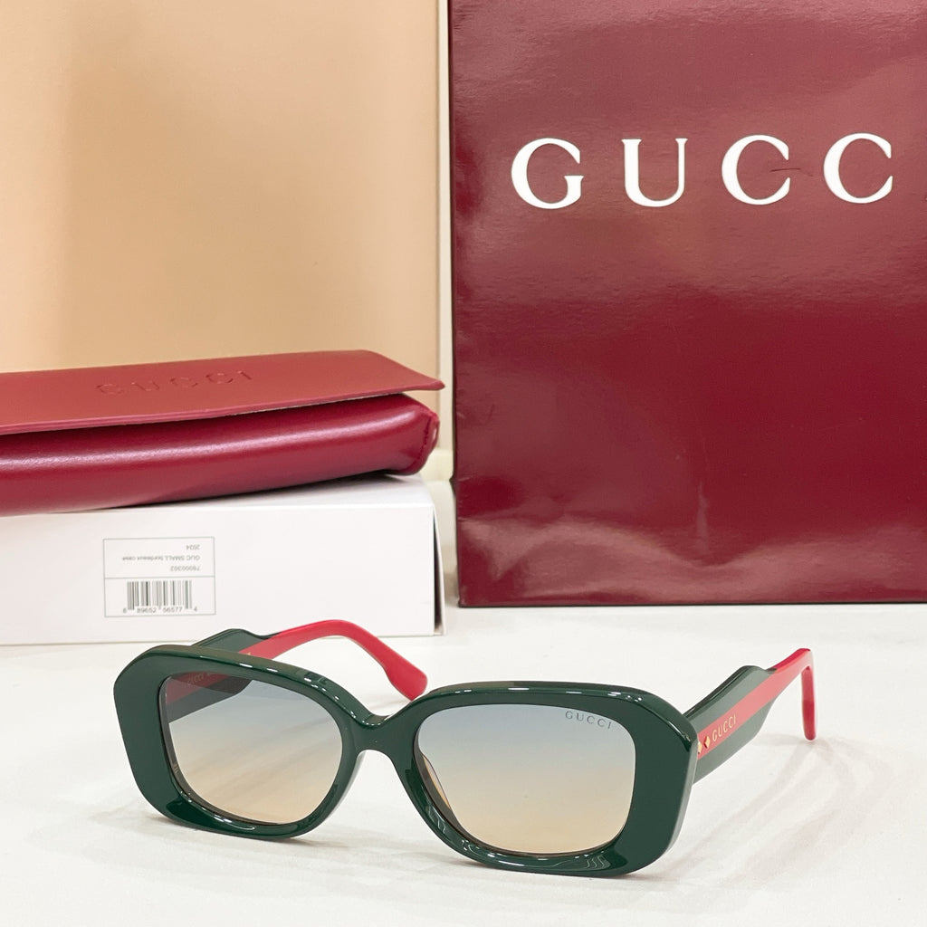 Gucci sunglasses, dark green cat-eye frames with light-tinted lenses
