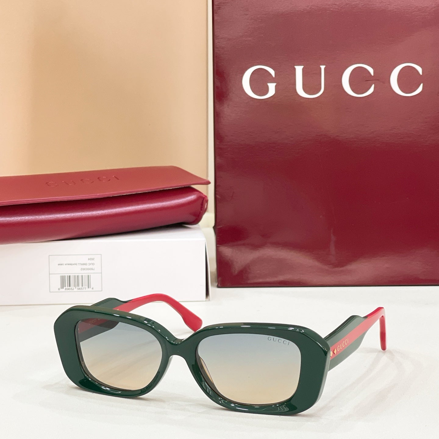Gucci sunglasses, dark green cat-eye frames with light-tinted lenses