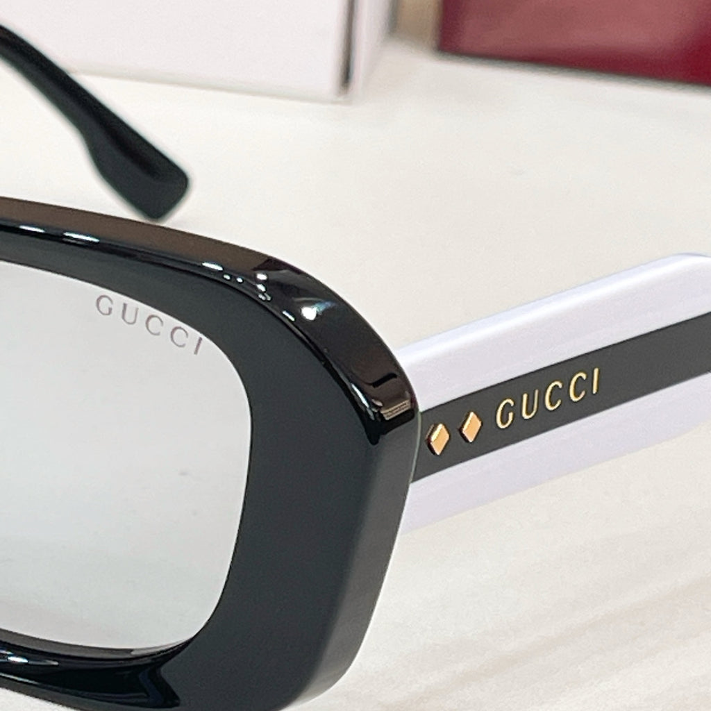 Gucci sunglasses, black temple with "GUCCI" logo lettering detail