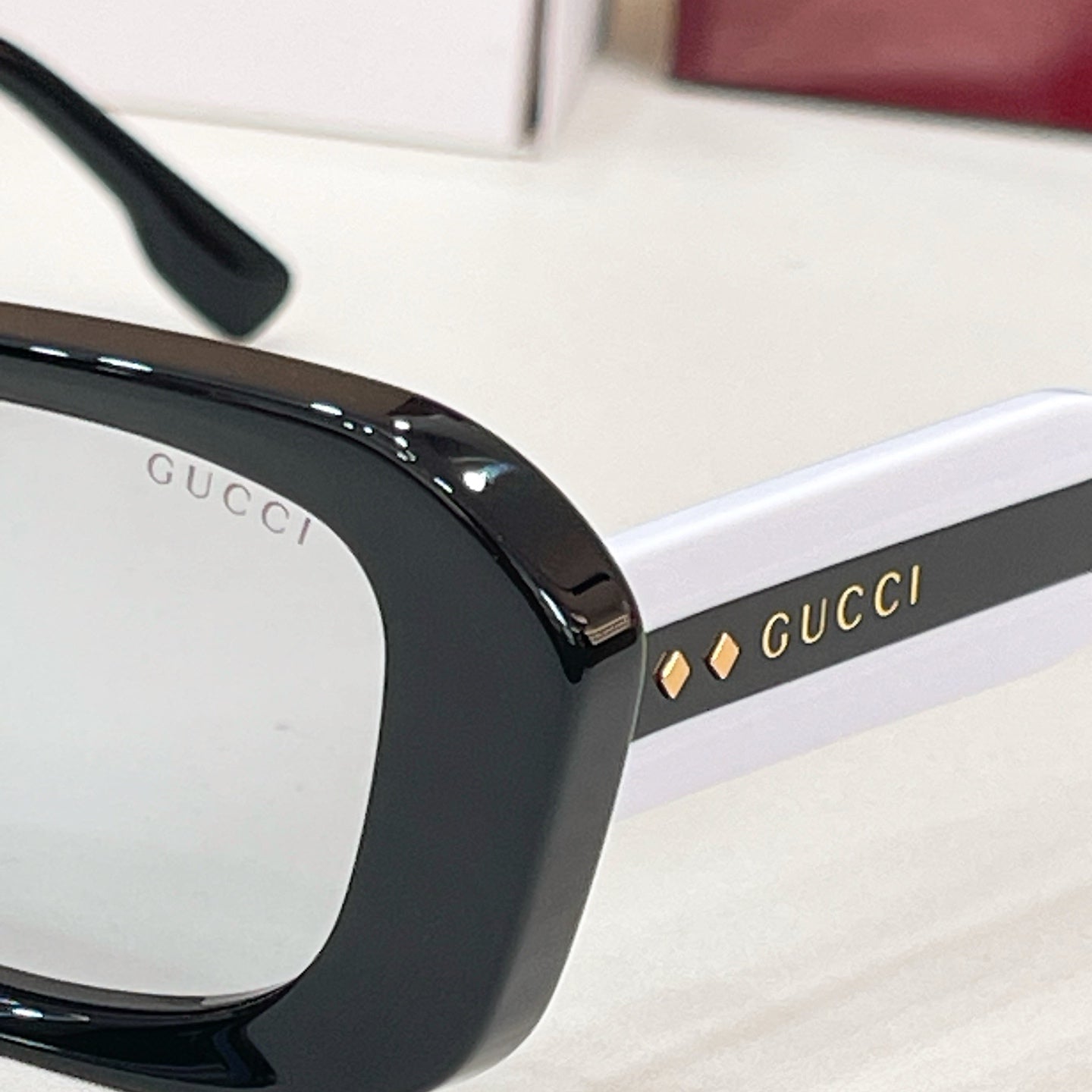 Gucci sunglasses, black temple with "GUCCI" logo lettering detail