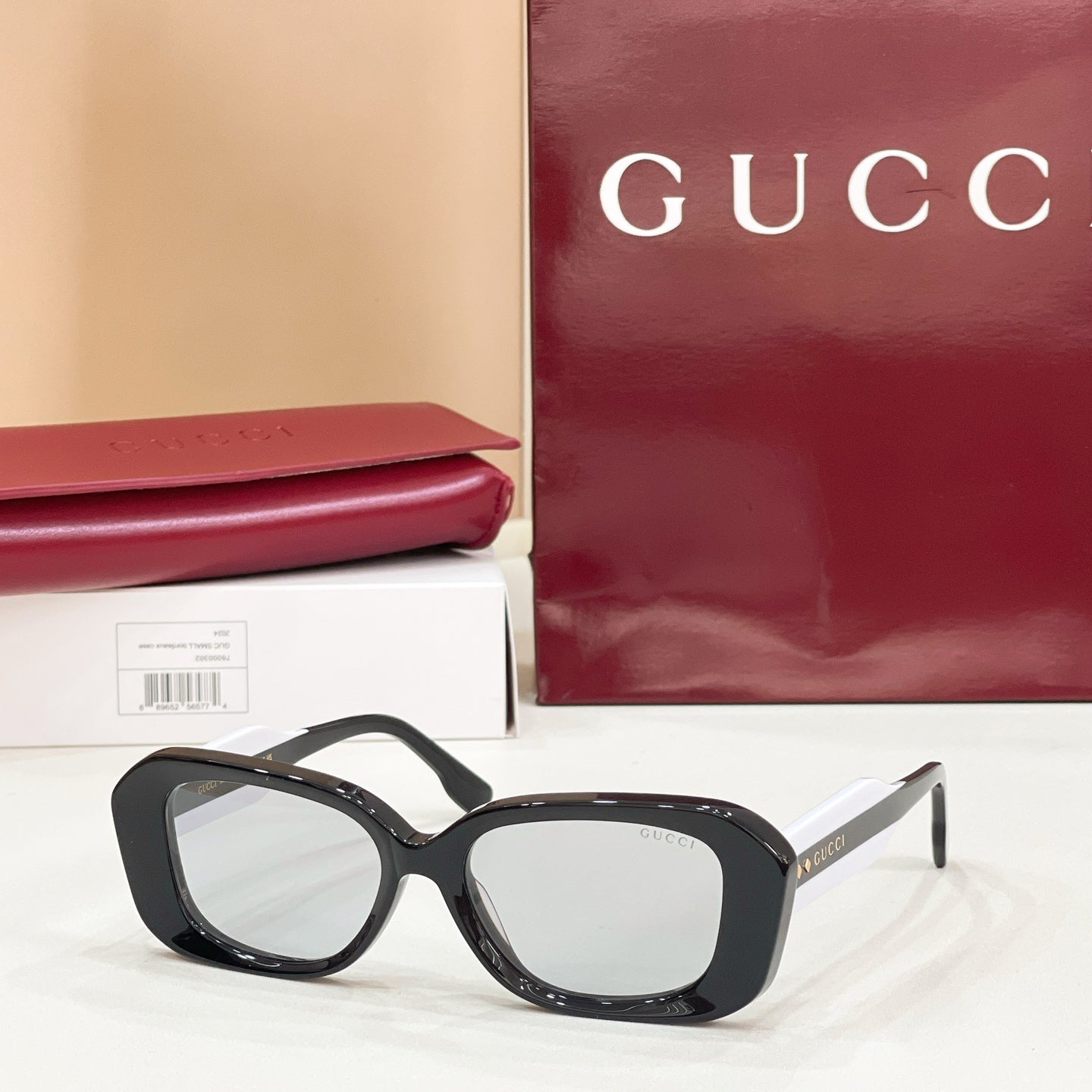 Gucci sunglasses, black cat-eye frames with clear lenses