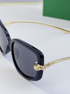 Navy-blue eyeglass frame with dark lenses and gold-tone temples
