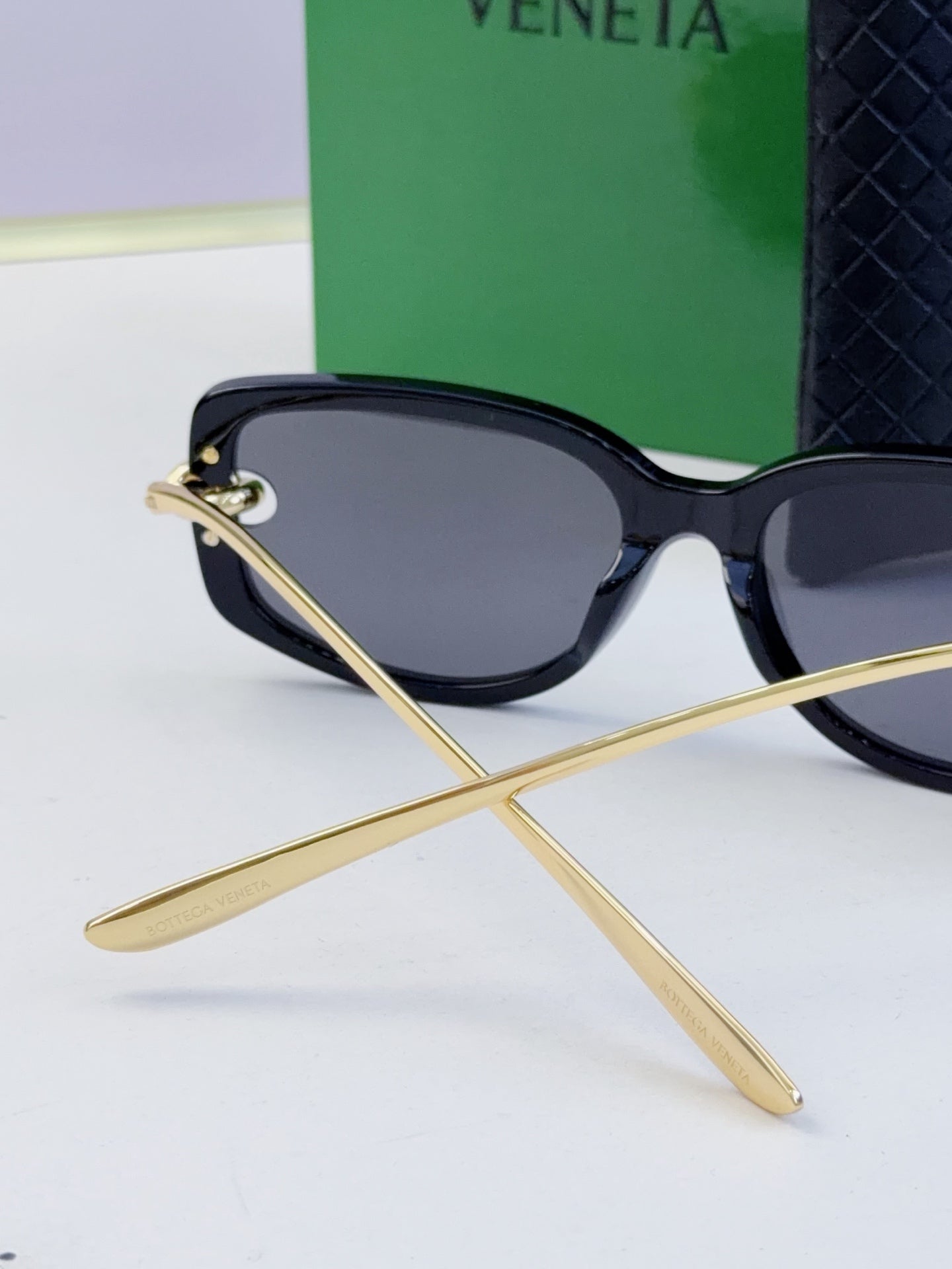 Black eyeglasses with dark lenses and gold-tone temples, side view