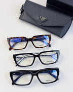 Three eyeglass frames with blue-tinted lenses and matching black case