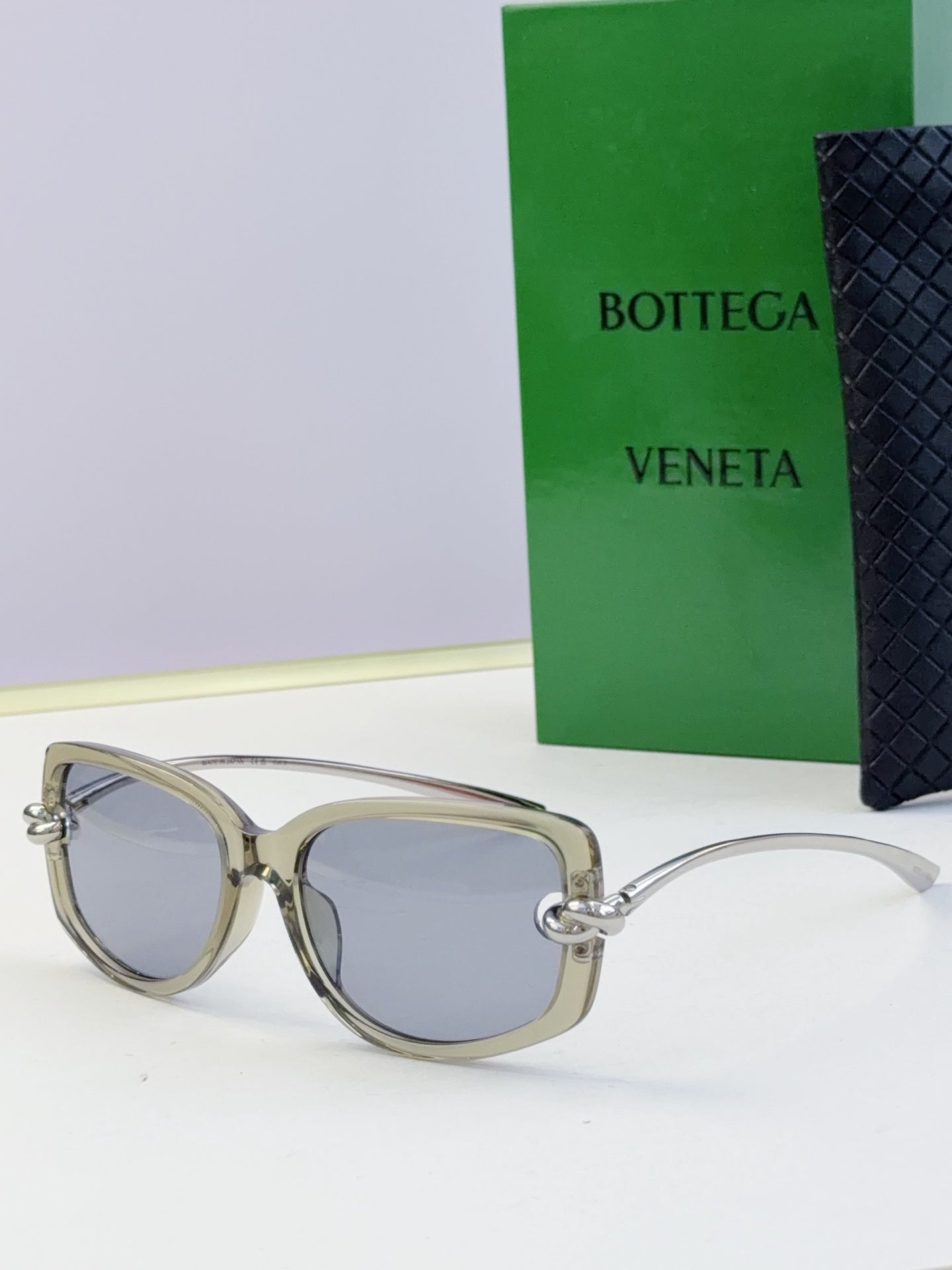 Silver-gray eyeglasses with blue-gray lenses and metallic temples