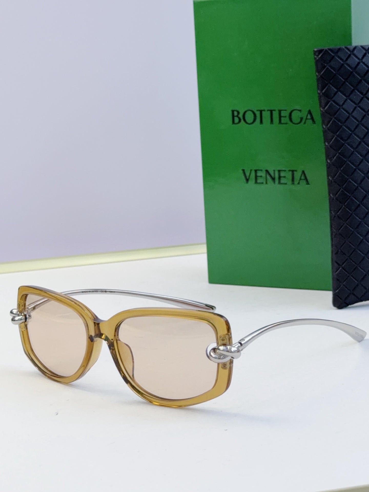 Gold-tone eyeglasses with light lenses and gold-tone temples