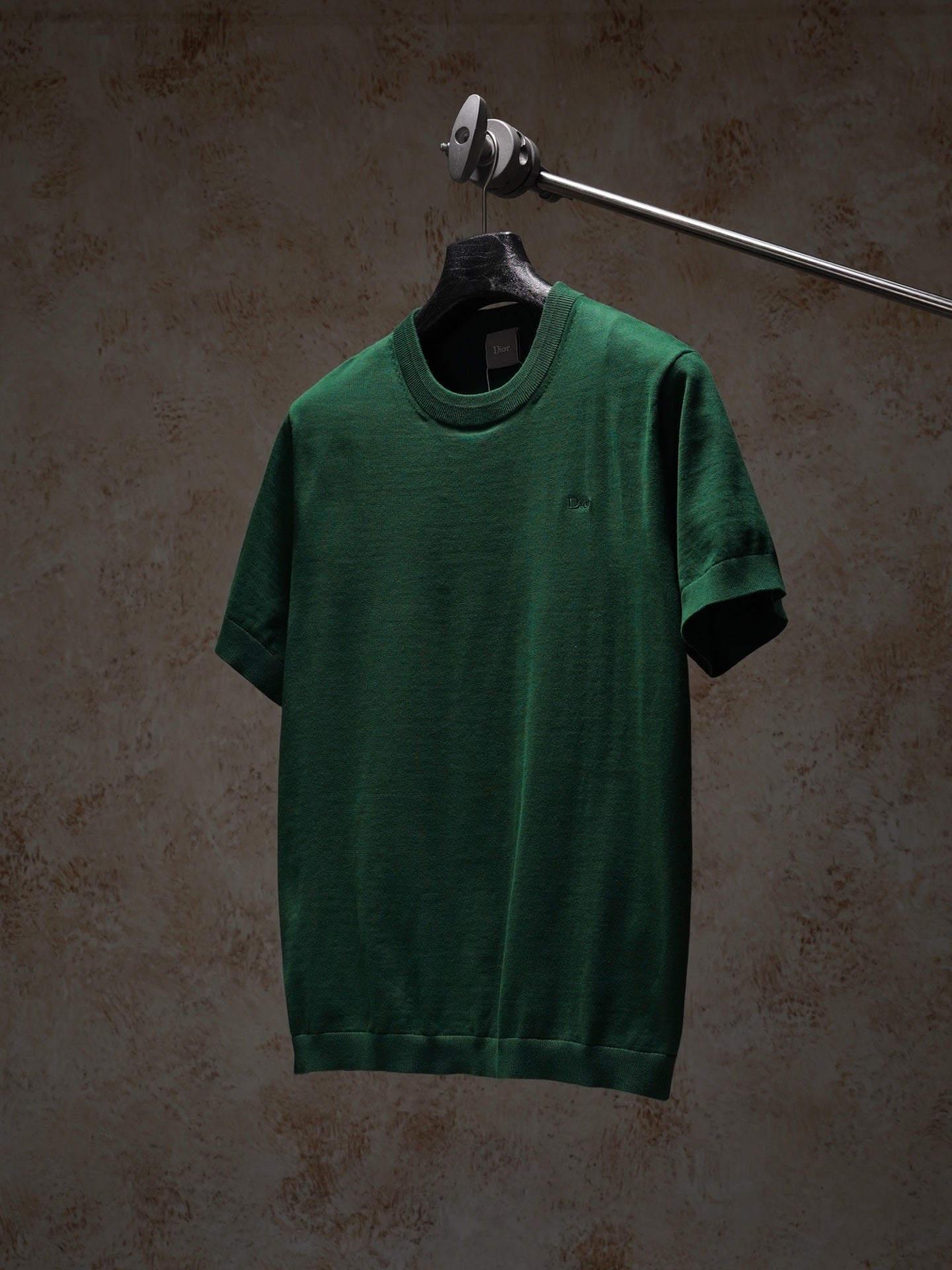 Green Dior crewneck short-sleeve knit top on hanger