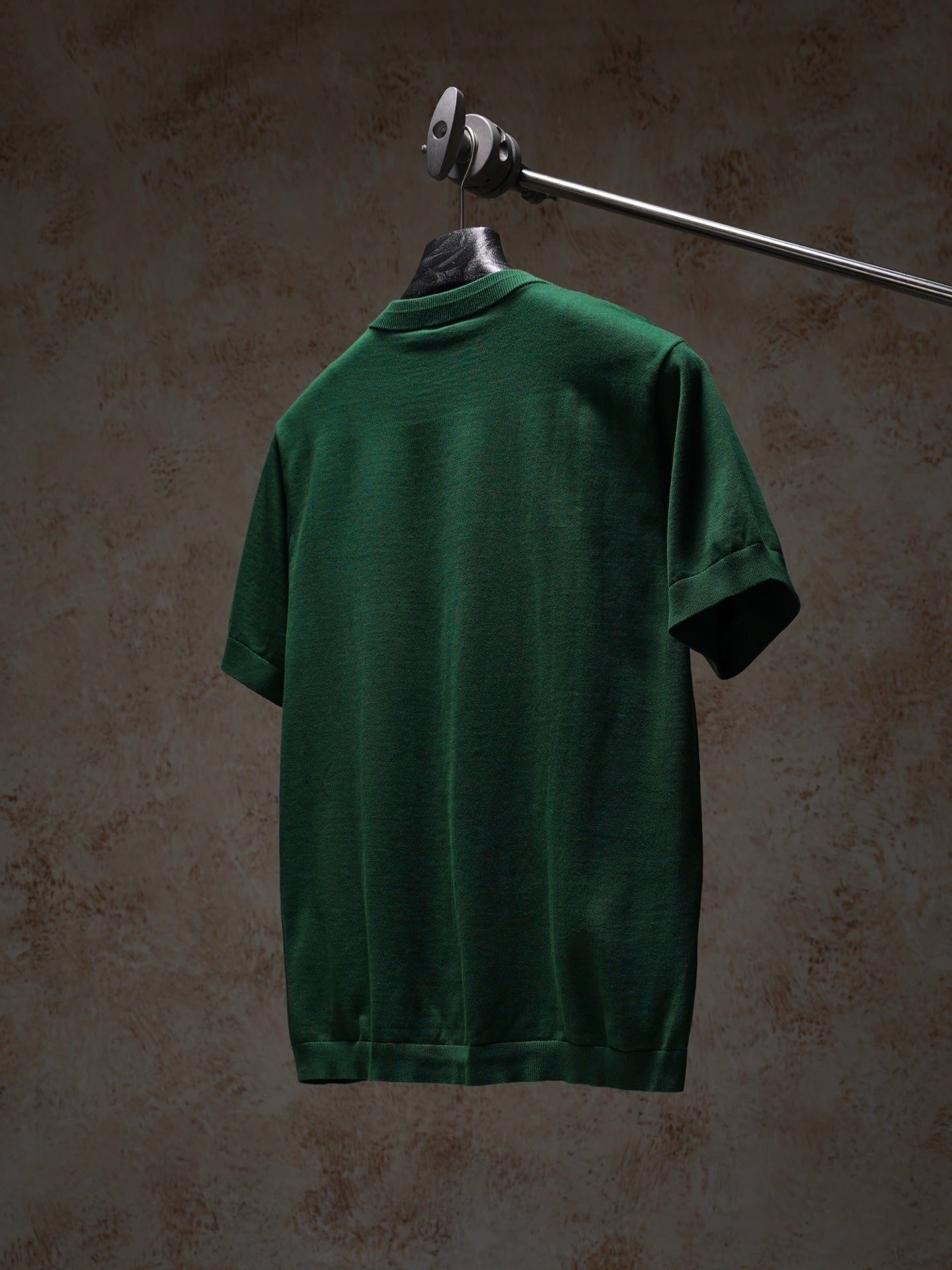 Green Dior crewneck short-sleeve knit top, back view on hanger