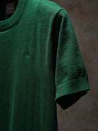 Green Dior crewneck knit top, close-up of sleeve and collar