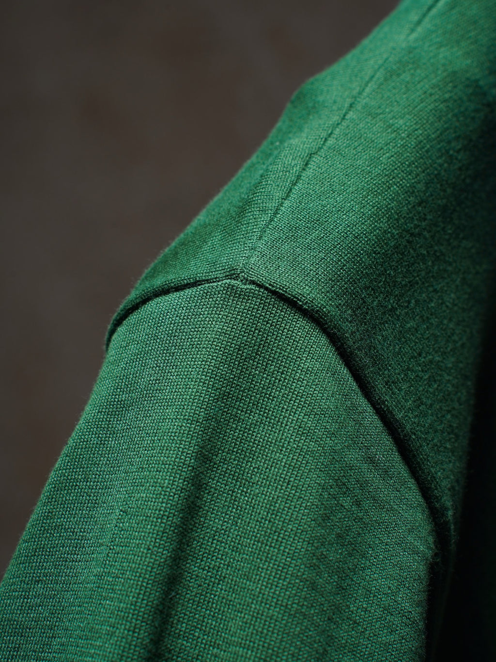 Green Dior knit top shoulder seam close-up