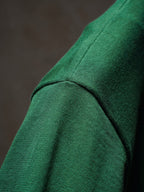 Green Dior knit top shoulder seam close-up