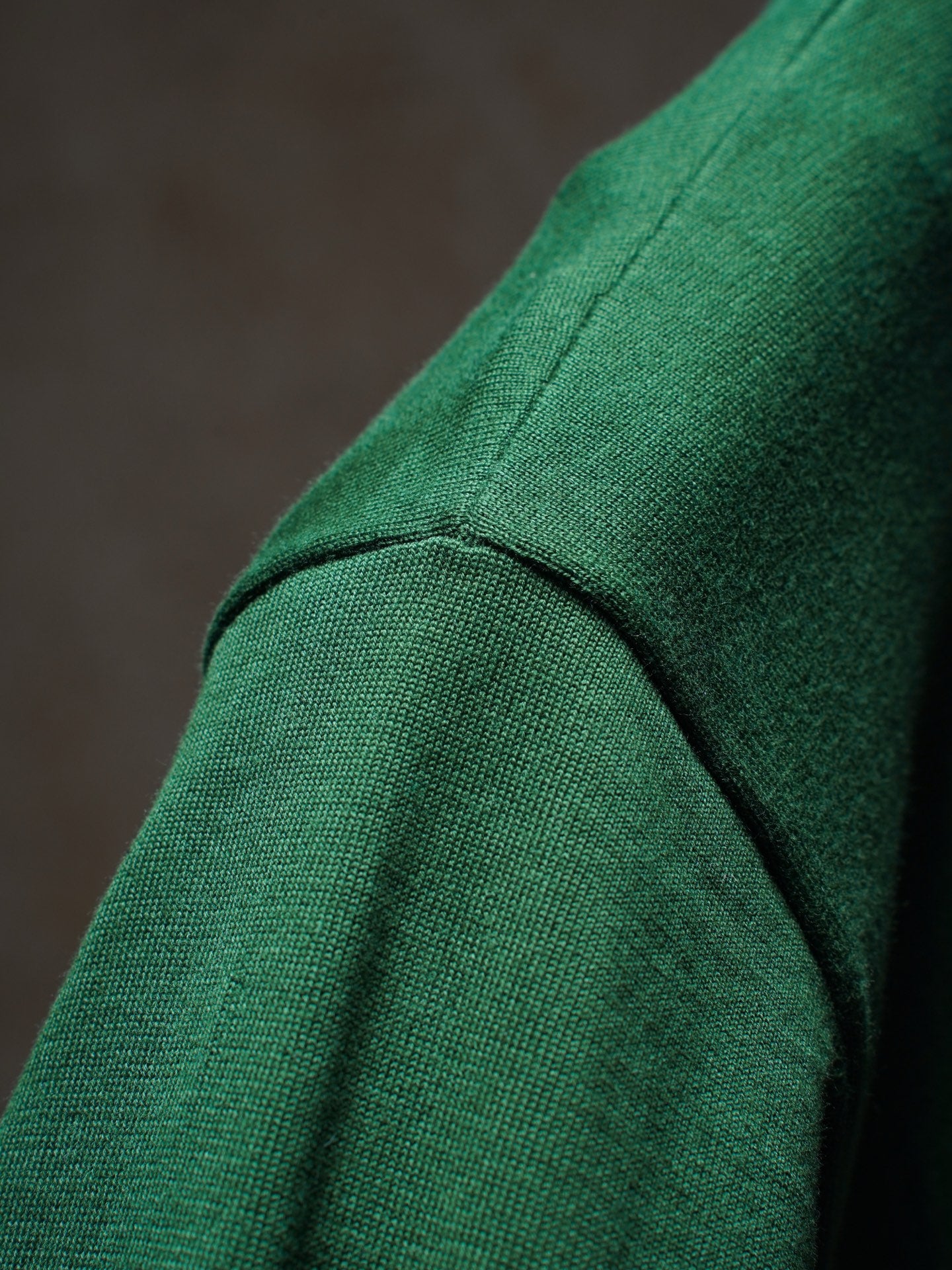 Green Dior knit top shoulder seam close-up