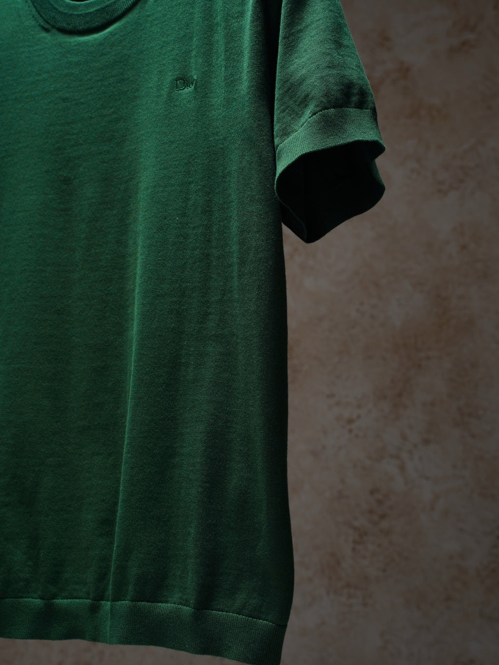 Green Dior crewneck knit top, side view on hanger