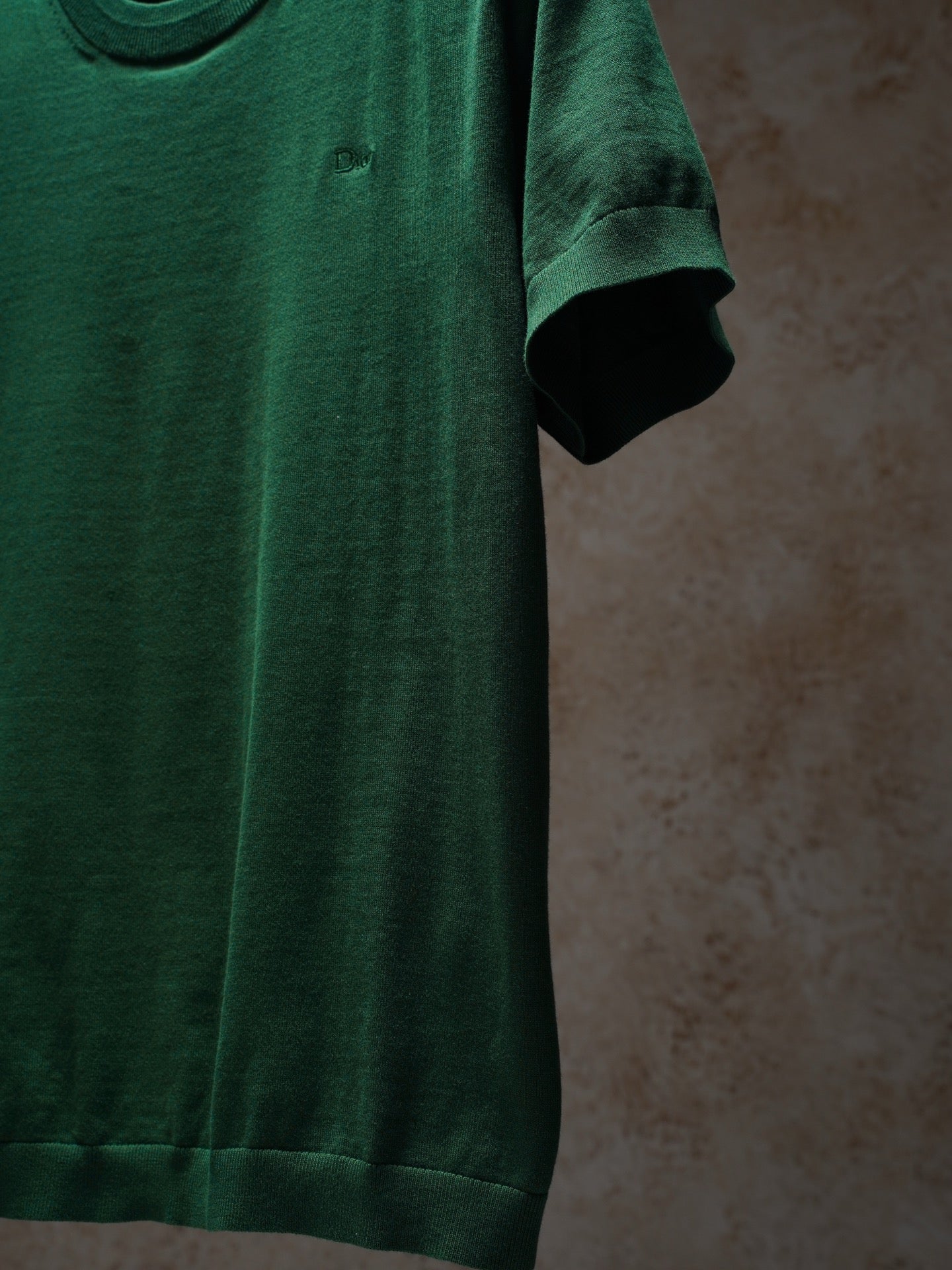 Green Dior crewneck knit top, side view on hanger