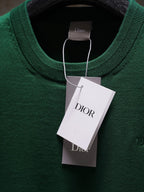 Dior green knit top with round neckline and hanging tag