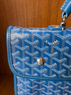 Blue patterned flap with logo plaque and gold-tone clasp, stitched trim