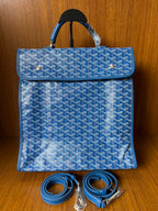 Blue patterned handbag with flap and matching shoulder strap, gold-tone hardware