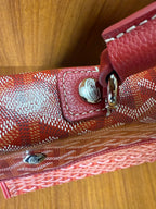 Red Goyard patterned handbag close-up of strap attachment and buckle hardware