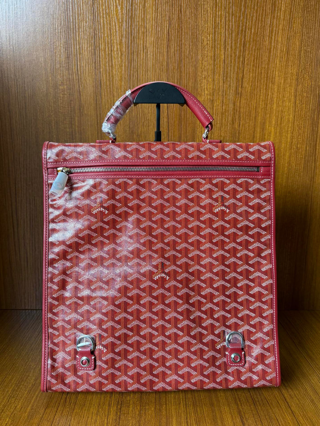 Red Goyard patterned handbag with zippered front pocket and top handle