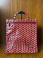 Red Goyard patterned handbag with zippered front pocket and top handle