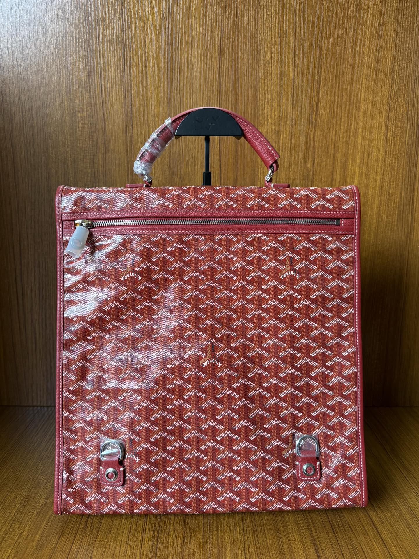 Red Goyard patterned handbag with zippered front pocket and top handle