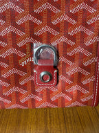 Red Goyard patterned handbag close-up of front clasp hardware