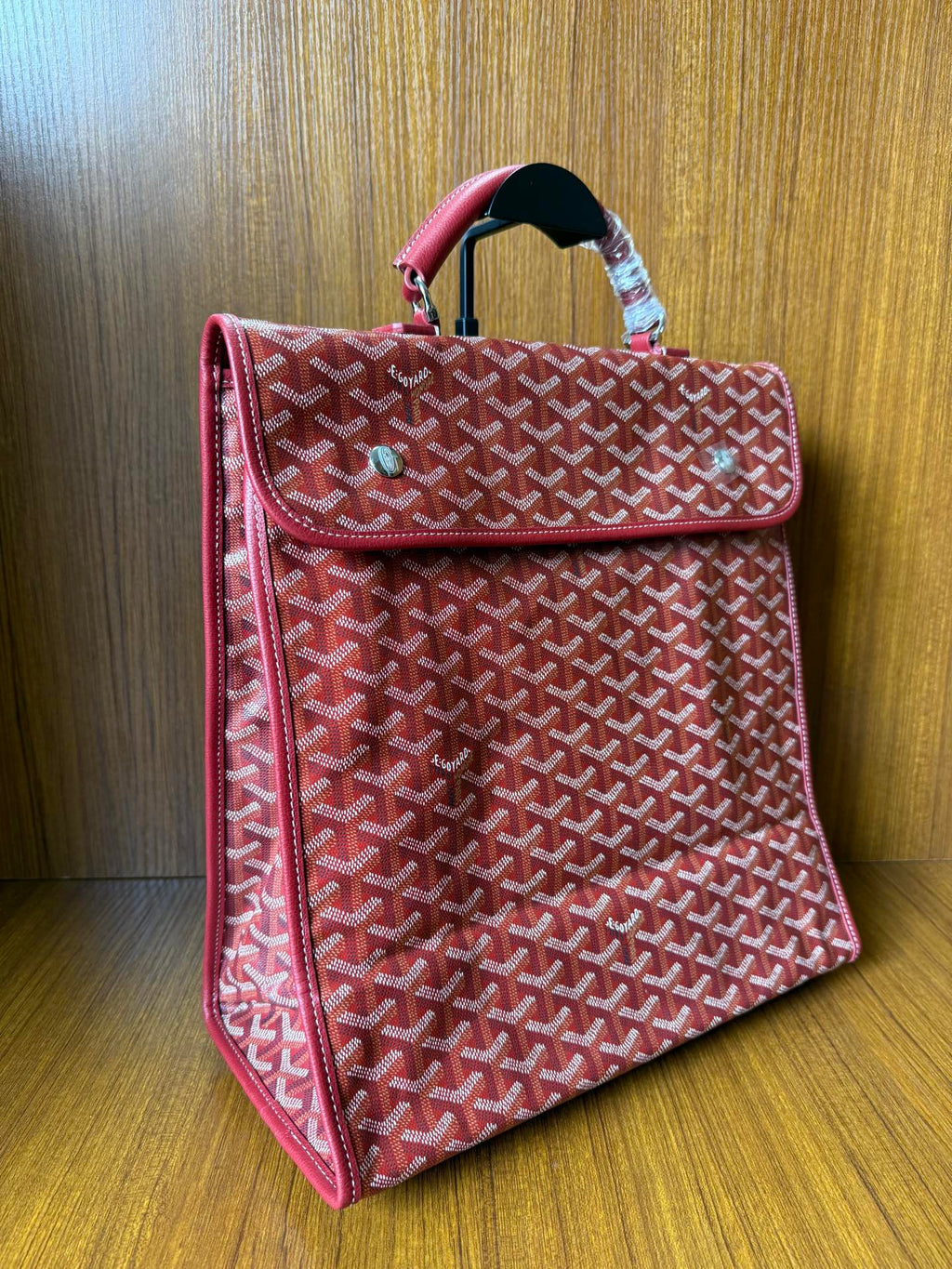Red Goyard patterned handbag with side flap, top handle, structured shape