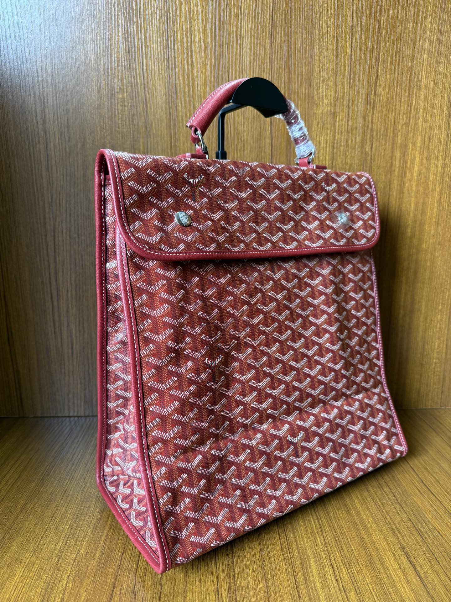 Red Goyard patterned handbag with side flap, top handle, structured shape