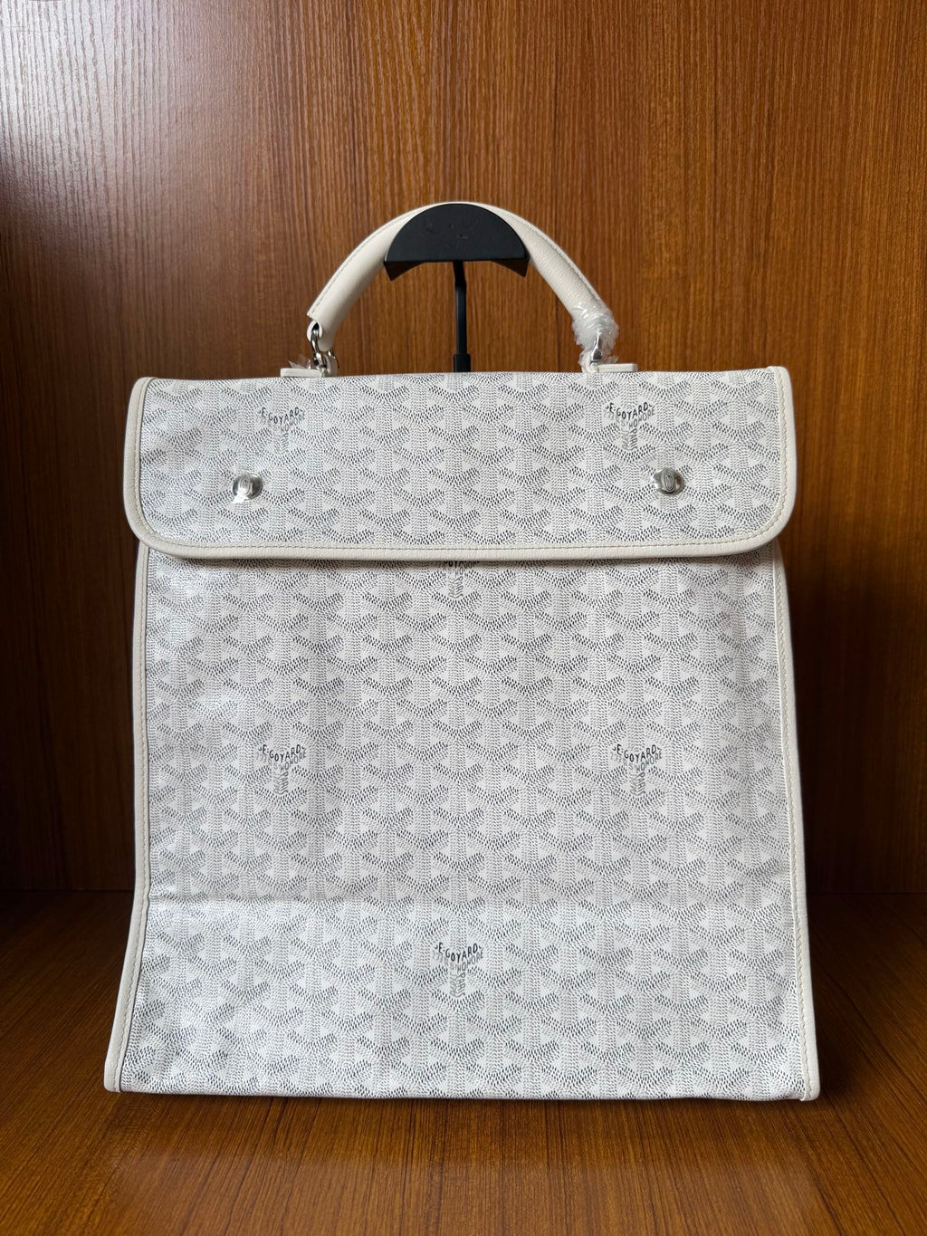 Designer monogram tote bag in light gray with top flap and white handles