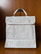 Designer monogram tote bag in light gray with top flap and white handles