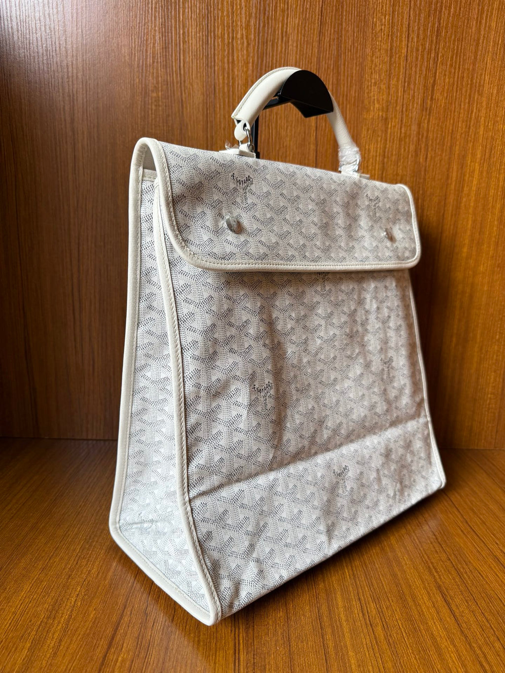 Designer monogram tote bag in light gray with side flap pocket and handles