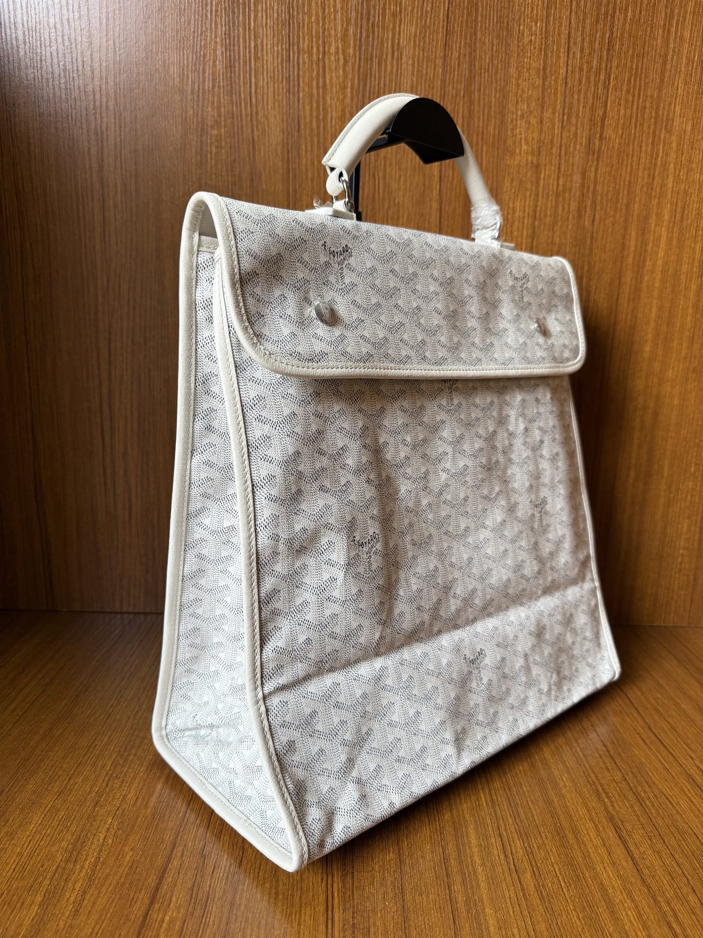 Designer monogram tote bag in light gray with side flap pocket and handles