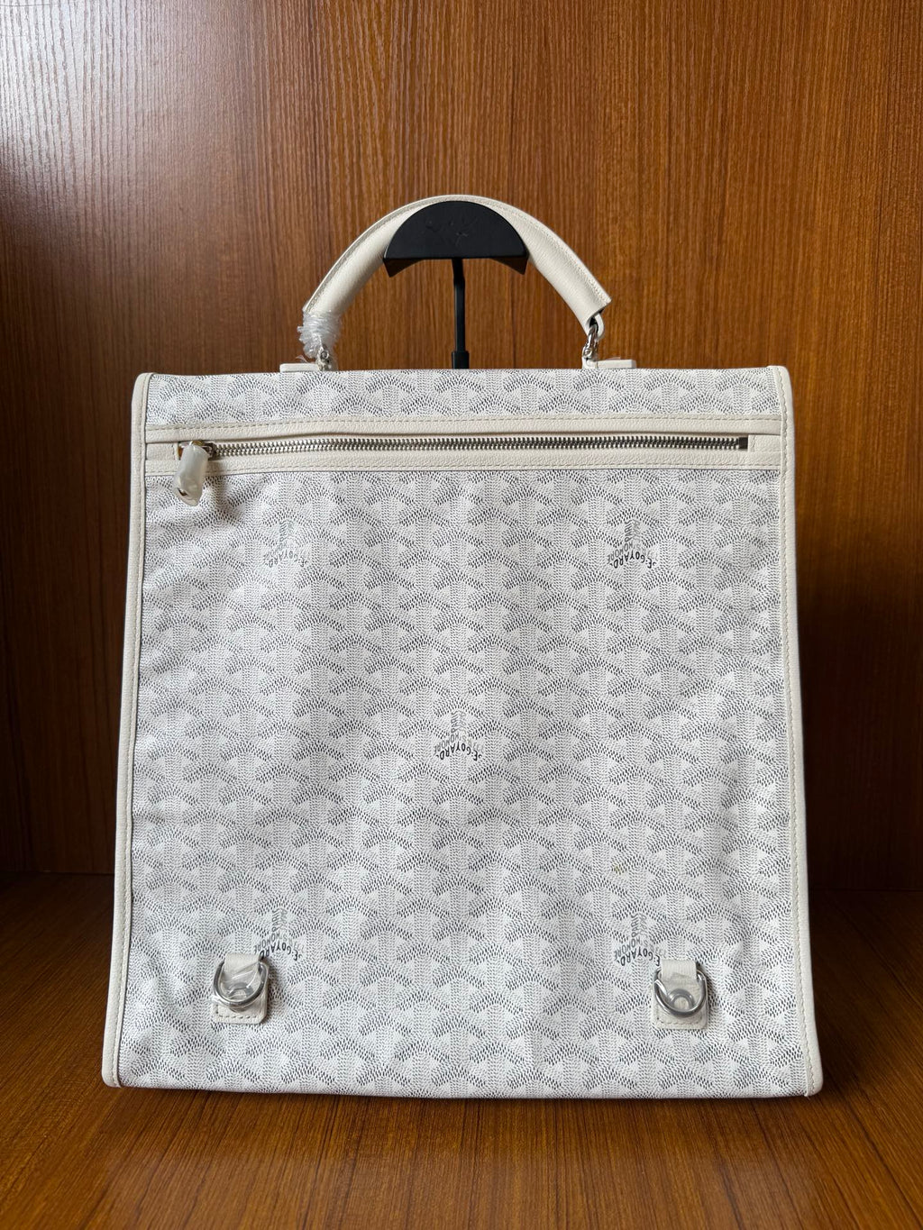 Designer monogram tote bag in light gray with zipper top and front hardware