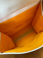 Designer tote bag interior lining in orange with flat base view
