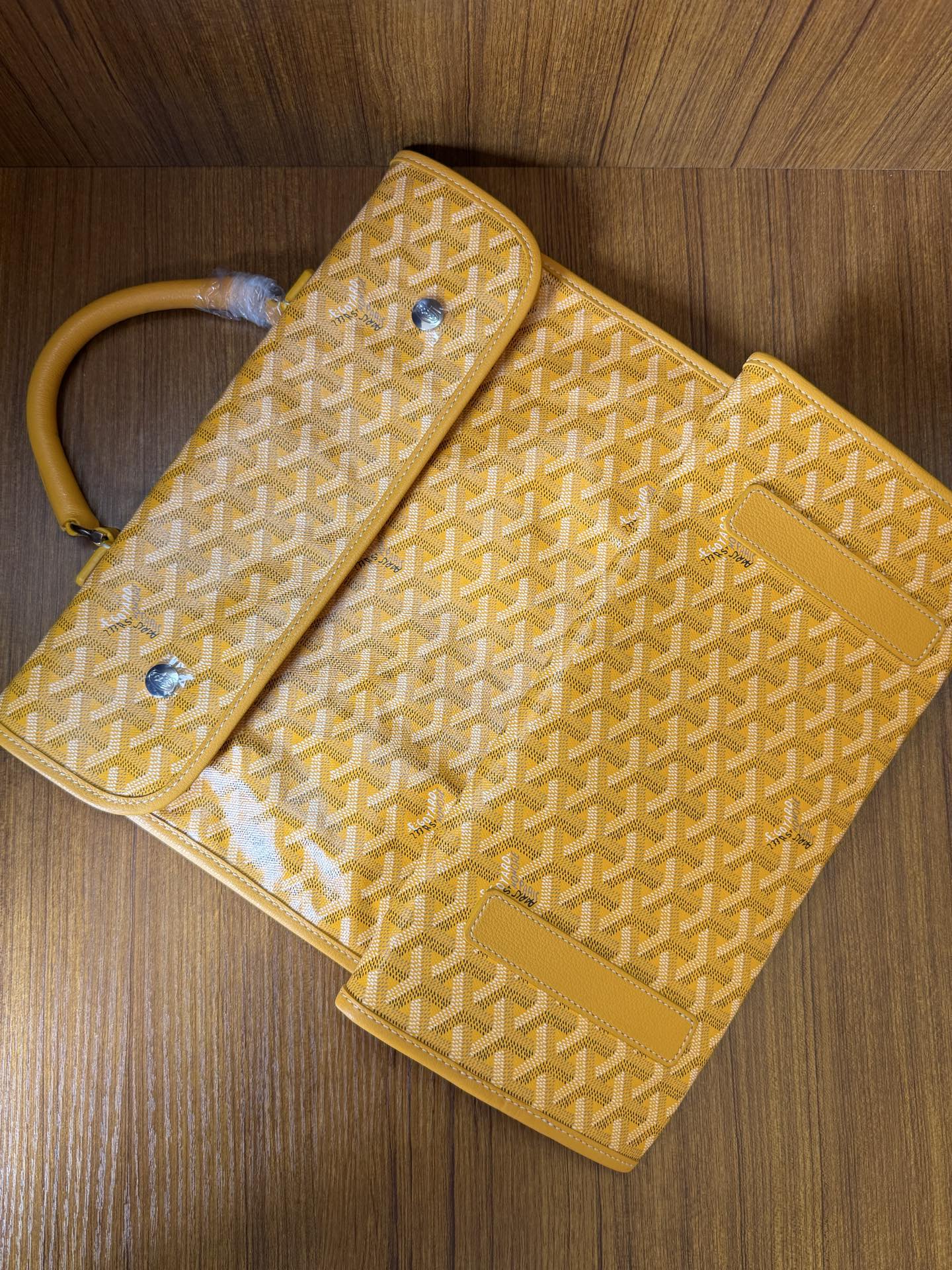 Yellow patterned tote bag with flap and side pouch detail