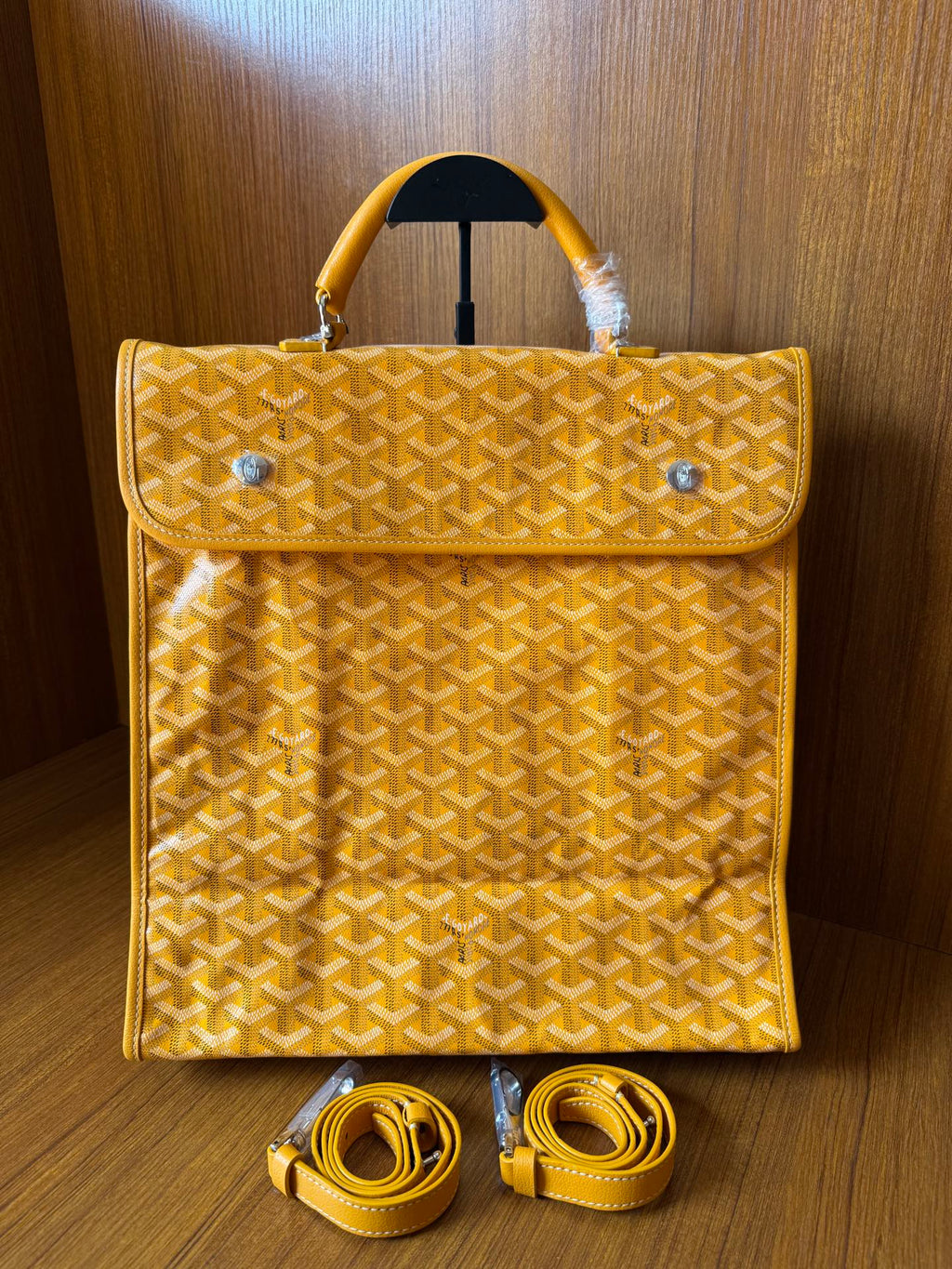 Yellow patterned tote bag with flap, top handles, and matching shoulder straps