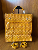 Yellow patterned tote bag with flap, top handles, and matching shoulder straps