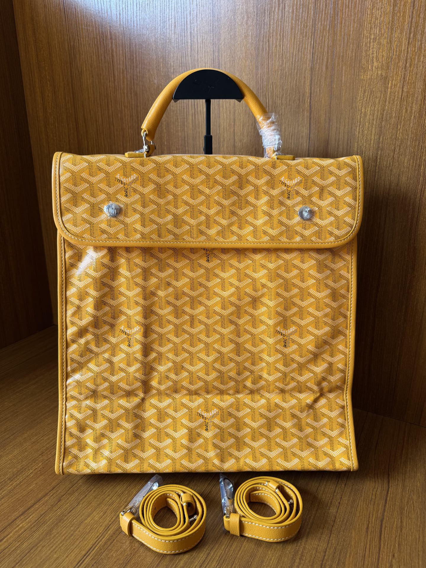 Yellow patterned tote bag with flap, top handles, and matching shoulder straps