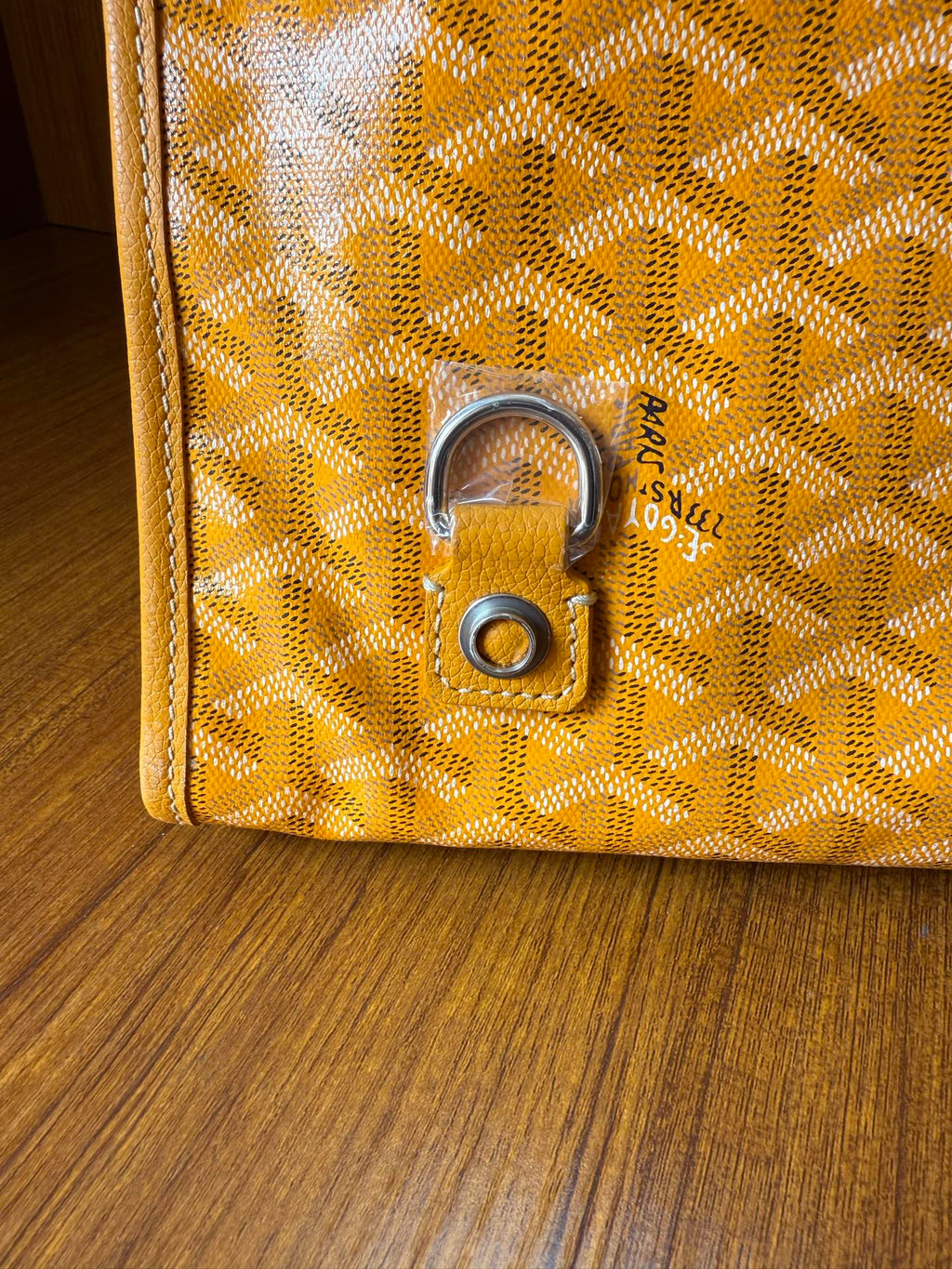 Yellow patterned tote bag with metal lock hardware and textured motif