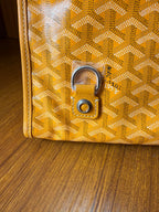 Yellow patterned tote bag with metal lock hardware and textured motif